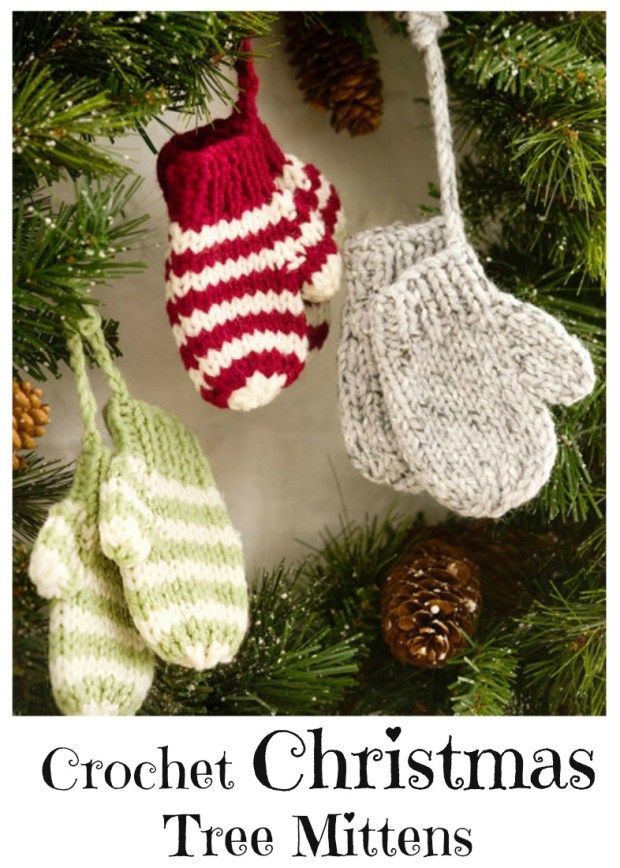 three knit mittens hanging from a christmas tree