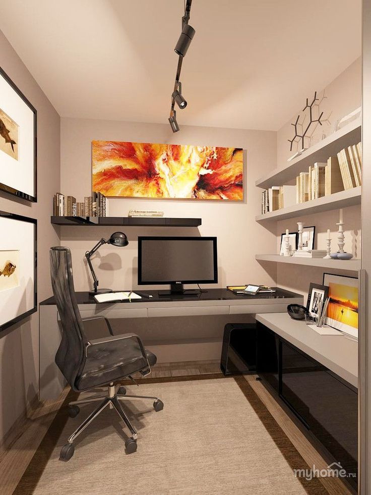 a home office with a desk, computer monitor and art on the wall above it