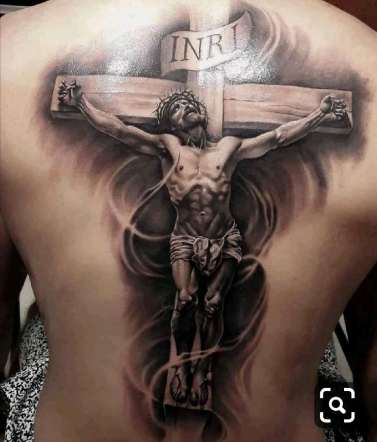 a man with a cross tattoo on his back