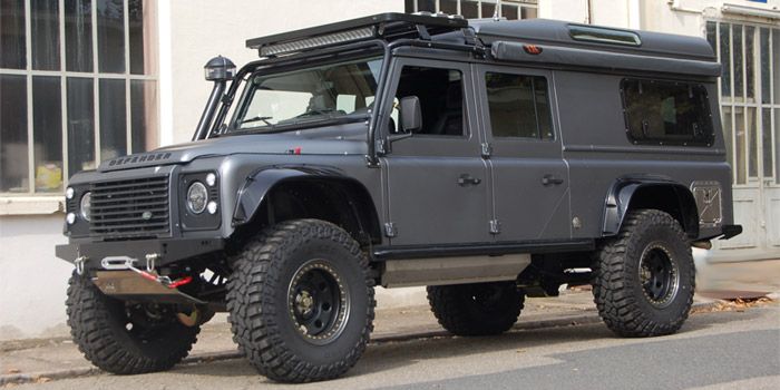 an off - road vehicle parked in front of a building