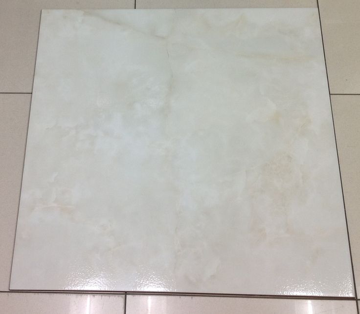 a tile floor with white tiles on it