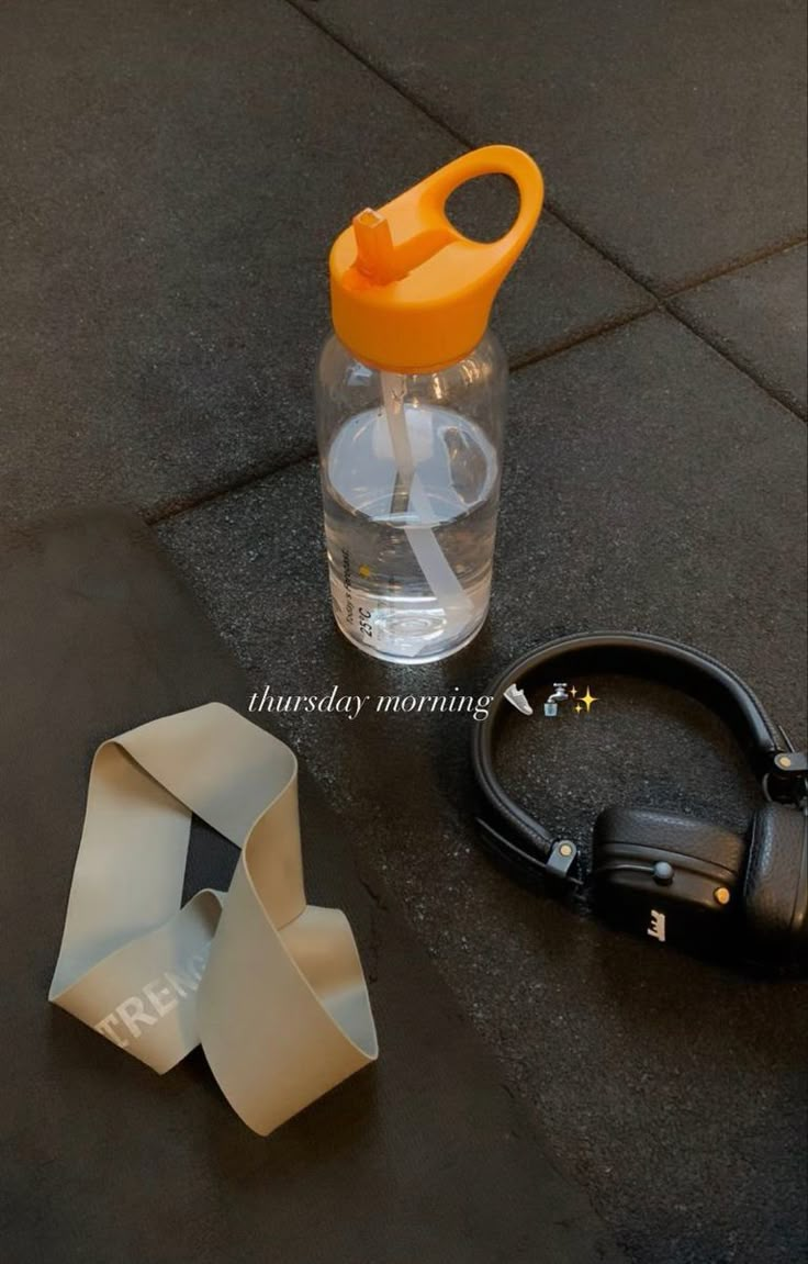 a pair of scissors sitting next to a water bottle