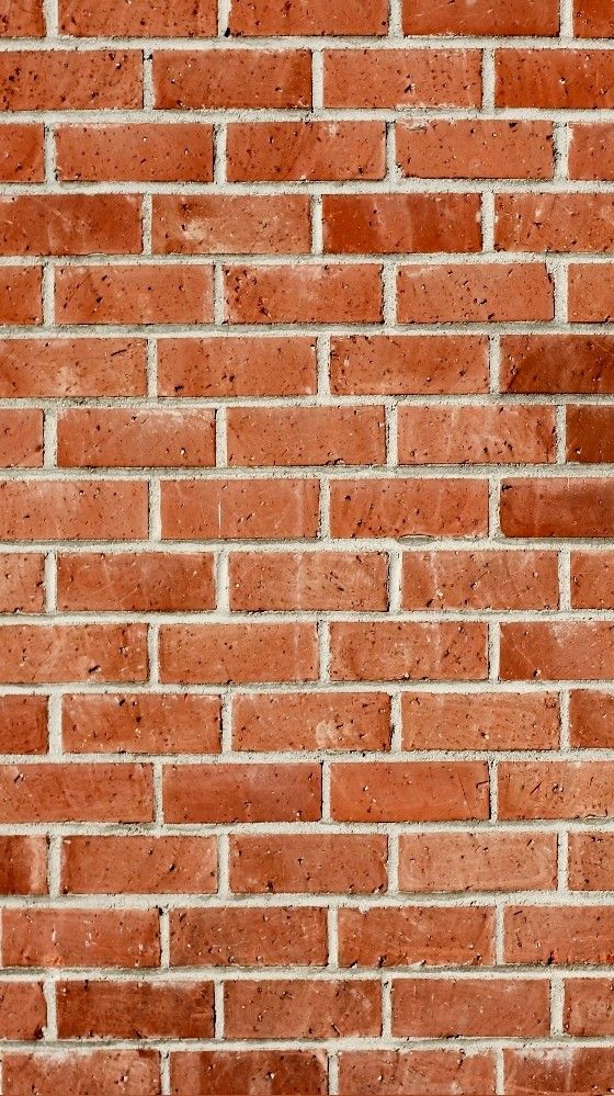 an orange brick wall with no mortars or mortars on the top and bottom