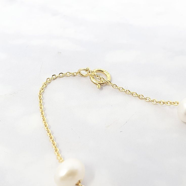 Our Freshwater Pearl Double Chain Wedding Bracelet, crafted with 18ct gold-plated copper and adorned with freshwater pearls, is the perfect elegant gift for brides, bridesmaids, or any special occasion.  Elevate your bridal ensemble with our Freshwater Pearl Double Chain Wedding Bracelet, an exquisite accessory perfect for bridesmaids or brides on their special day.   This jewellery arrives beautifully packaged and ready to gift. It would make a really thoughtful and meaningful birthday gift, Ch Elegant Gold Single Strand Bridal Necklace, Elegant Single Strand Gold Bridal Necklace, Wedding Baroque Pearl Chain Bracelet, Elegant Gold Bracelet With Baroque Pearl, Delicate Baroque Pearl Bracelet With Pearl Chain, Delicate Baroque Pearl Chain Bracelet, Delicate Baroque Pearl Bracelet, Refined Yellow Gold Pearl Necklace For Wedding, Refined Gold Wedding Jewelry