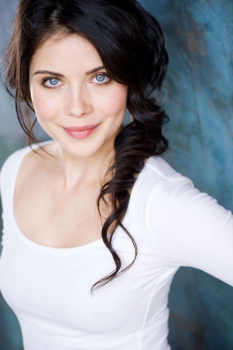 a woman in white shirt posing for a photo