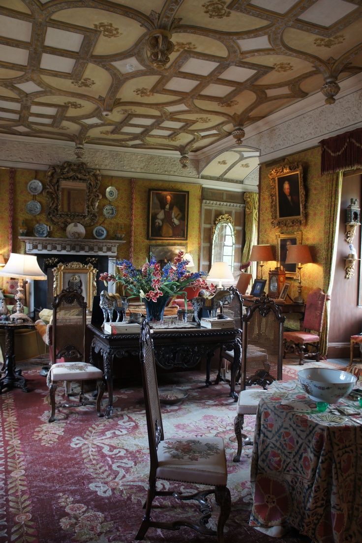 an ornately decorated dining room with fancy furniture and paintings on the wall above it