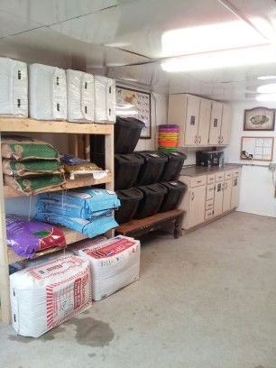 the storage room is filled with boxes and other items, including bags on shelves that are stacked high