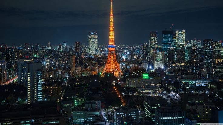 the eiffel tower lit up at night in paris, france as seen from above