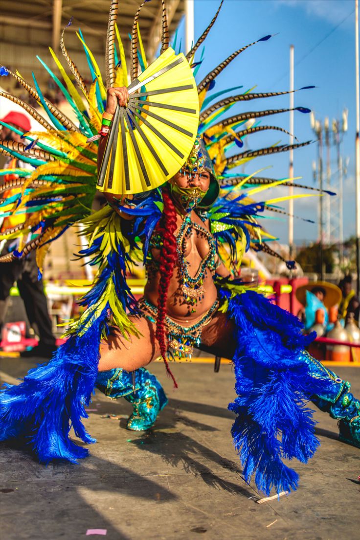 a woman in blue and yellow costume dancing