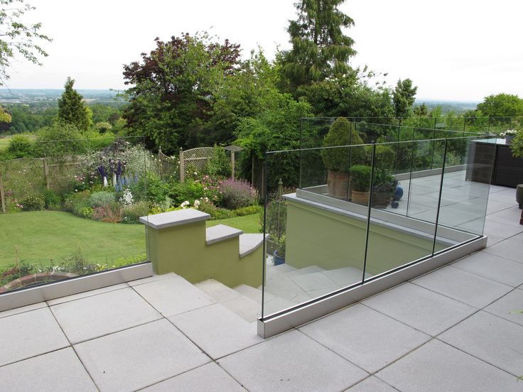 a glass railing on top of a patio