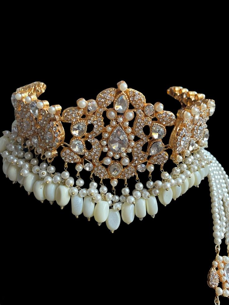 A must have for the upcoming wedding season! This bridal set is a unique blend of royal and modern with its pastel hues and gold plating. The set is gorgeous with pearls and is a full bridal piece but can be worn separately for a lighter and simple look. Set includes: mala , earrings, maang tikka , passa, choker In stock and ready to ship‰Û? Elegant Bridal Earrings With Stone Work And Pearl, Elegant Pearl Bridal Earrings With Stone Work, Kundan Bridal Earrings With Pearl Drop For Wedding, Elegant White Bridal Sets With Pearl Drop, Elegant Kundan Bridal Earrings, Elegant Kundan Bridal Earrings For Wedding, Elegant Kundan Bridal Earrings For Marriage, Gold Bridal Accessories With Stone Work For Wedding, Luxury Gold Pearl Necklace For Wedding