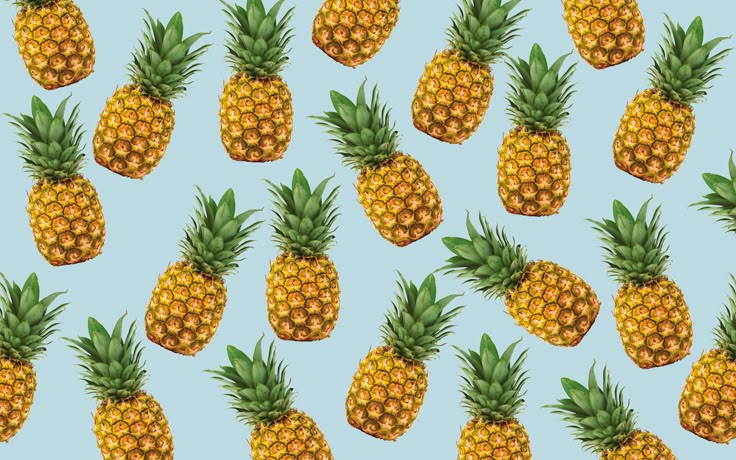 many pineapples are arranged on a blue background