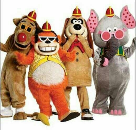 five people dressed in animal costumes standing next to each other with one person wearing an elephant costume