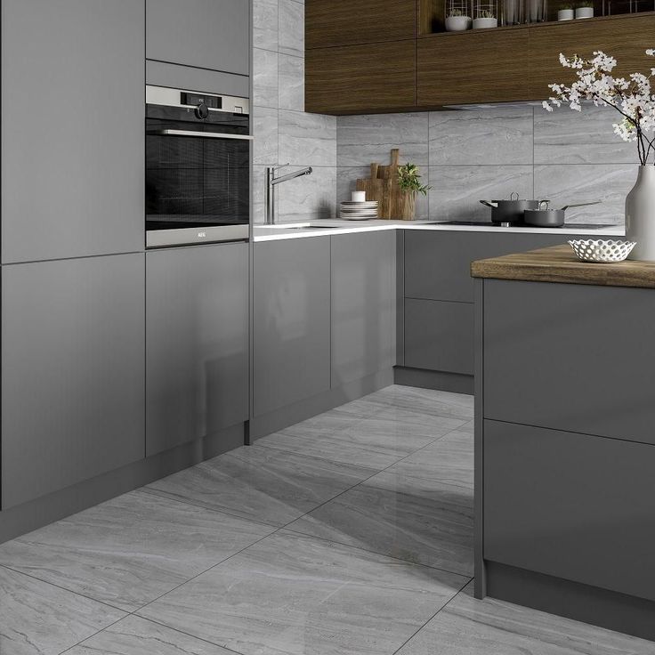 a modern kitchen with gray cabinets and marble counter tops