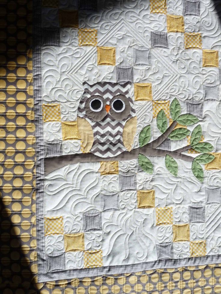 an owl is sitting on a tree branch with yellow and gray squares around it's edges