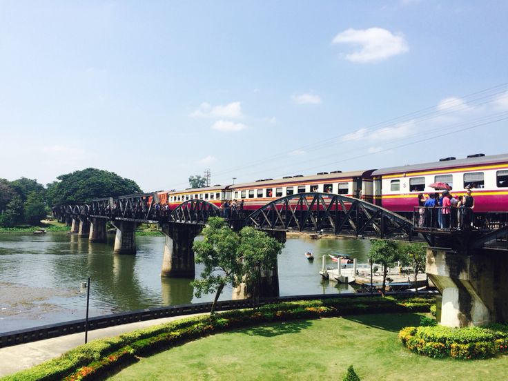 a train traveling over a bridge next to a river