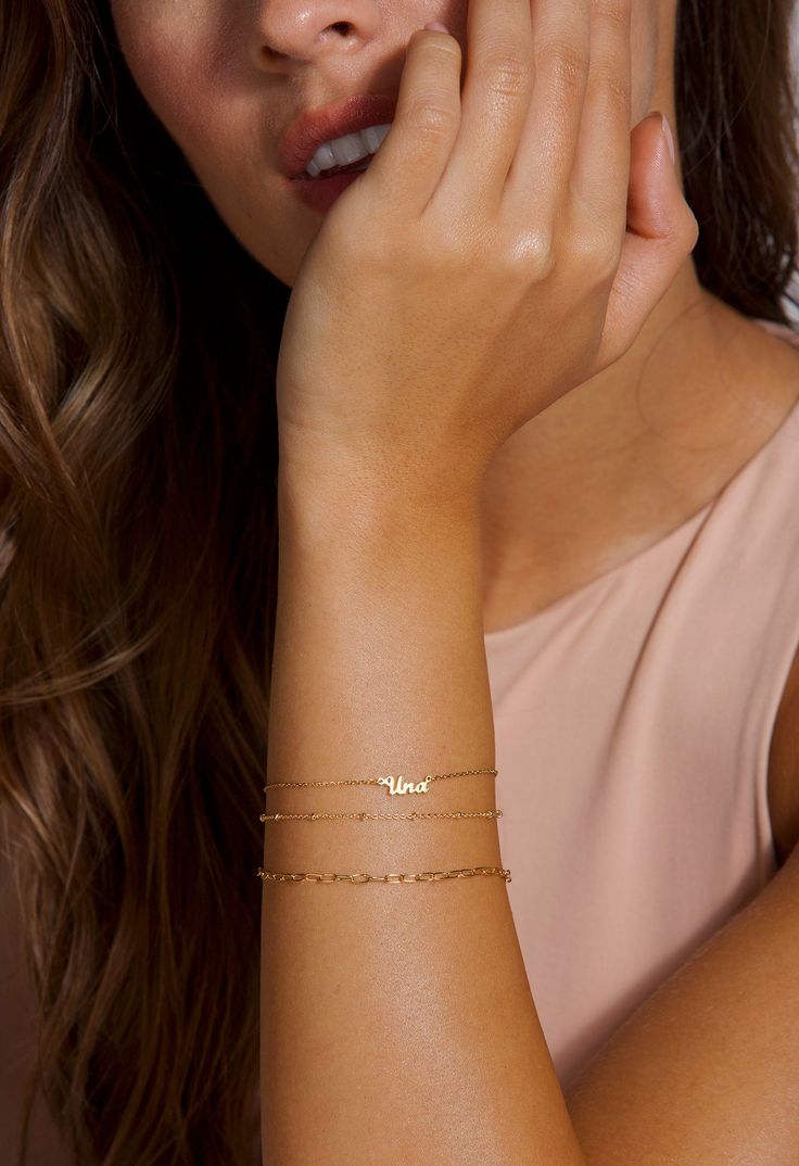 The prettiest personalized gold bracelet gift for women! Layer as shown or wear it alone! DETAILS: Model is wearing a 14k solid gold personalized name bracelet. This item includes only the name bracelet, for the layered options bracelets see links below. LAYERING LOOK: Beaded Bracelet: https://www.etsy.com/listing/736956390/beaded-satellite-bracelet-gold-beaded?ref=shop_home_active_17&pro=1&frs=1 Open Link Bracelet: https://www.etsy.com/listing/737308052/gold-link-bracelets-gold-bracelet Mother's Day Yellow Gold Name Bracelet, Personalized Name Bracelet For Everyday Use, Personalized Name Bracelet For Everyday, Personalized 14k Gold Chain Bracelet, Delicate Personalized Name Bracelet, Dainty Name Chain Bracelet, Dainty 14k Rose Gold Name Bracelet, Dainty Name Bracelet For Everyday Wear, 14k Gold Charm Bracelet For Anniversary