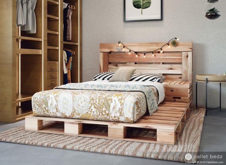 a bed made out of wooden pallets in a bedroom