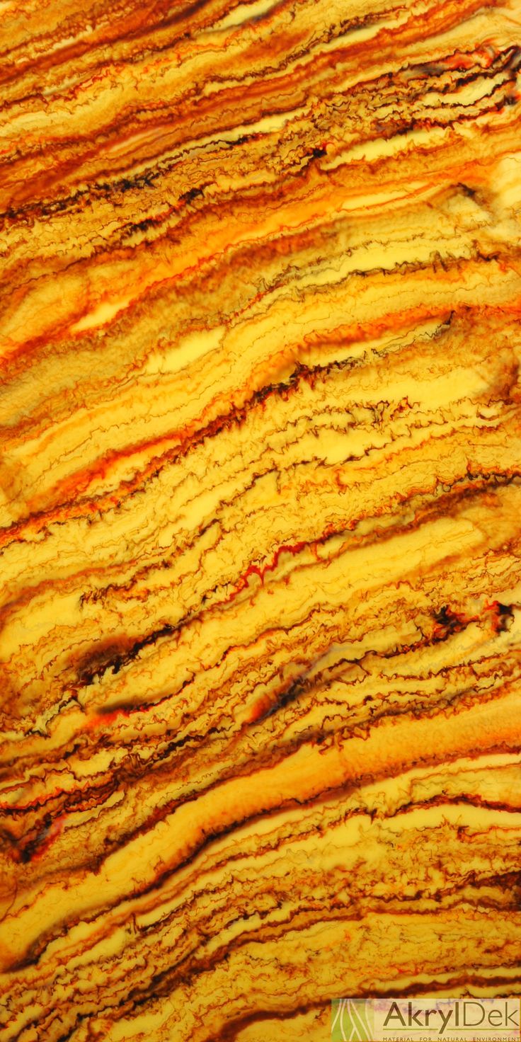 an orange and yellow marble counter top with streaks of light colored paint on the surface