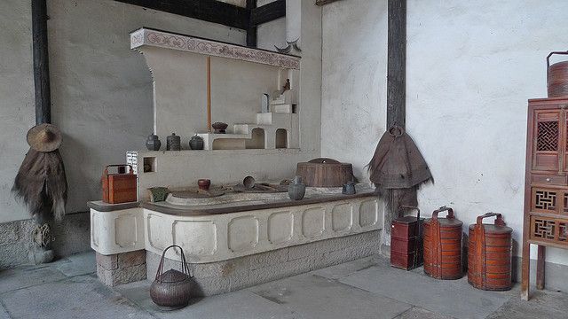 an old kitchen with pots and pans on the counter