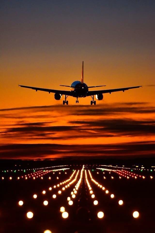 an airplane taking off into the sky at night with many lights in front of it