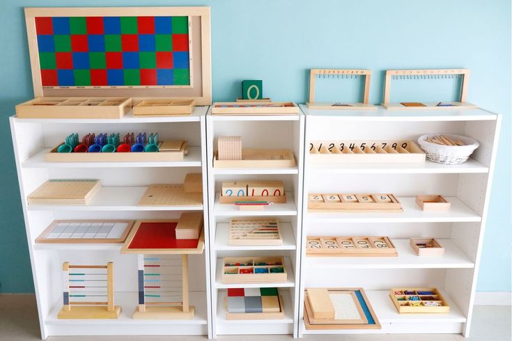 the shelves are filled with wooden toys and other small items for playrooms or children's rooms