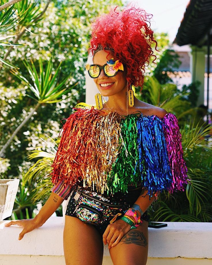 a woman with red hair and glasses posing for the camera