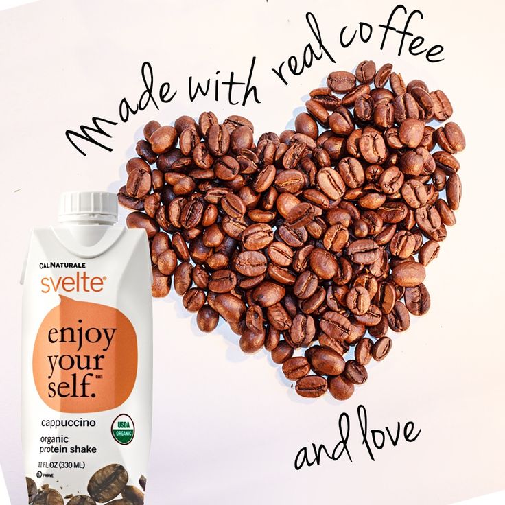 coffee beans in the shape of a heart next to a bottle of coffee