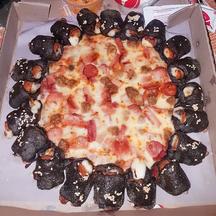 a pizza in a box with toppings on it