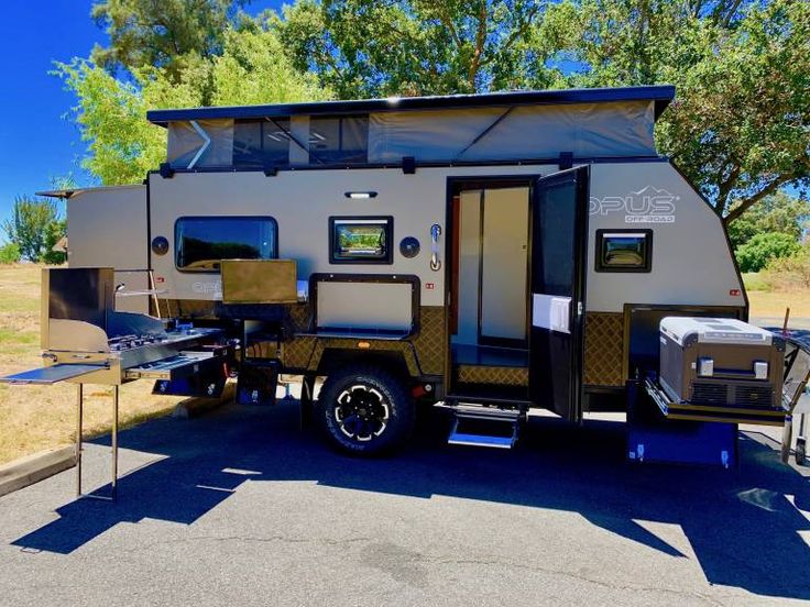 an rv parked on the side of the road with its door open and windows closed