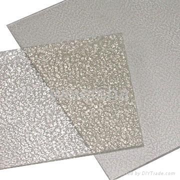 three different colors of glass with white and silver glitters on them, one in the middle