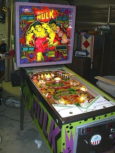 a pinball machine sitting inside of a garage