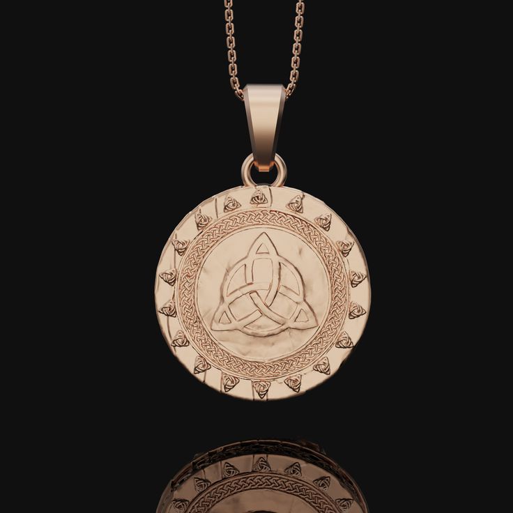 a pendant with an image of a celtic knot in the center on a black background