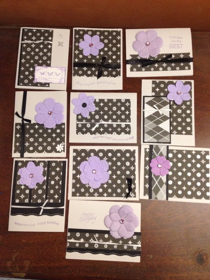 several cards with purple flowers on them sitting on a table