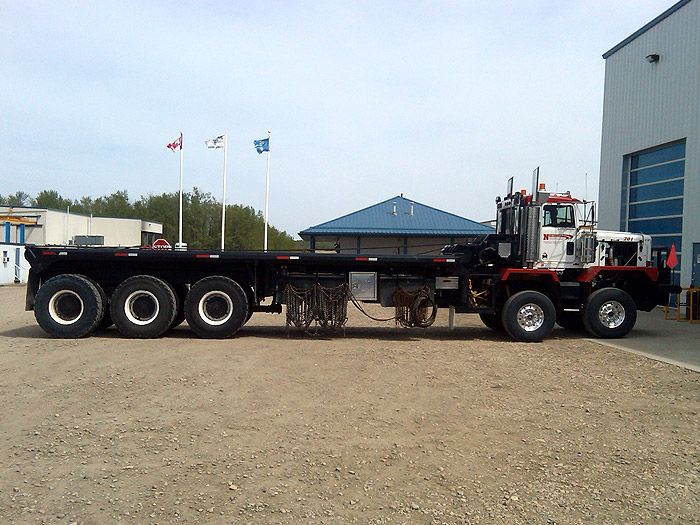 a large truck parked in front of a building