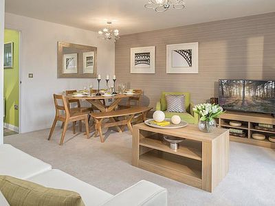 a living room filled with furniture and a flat screen tv on top of a wooden table