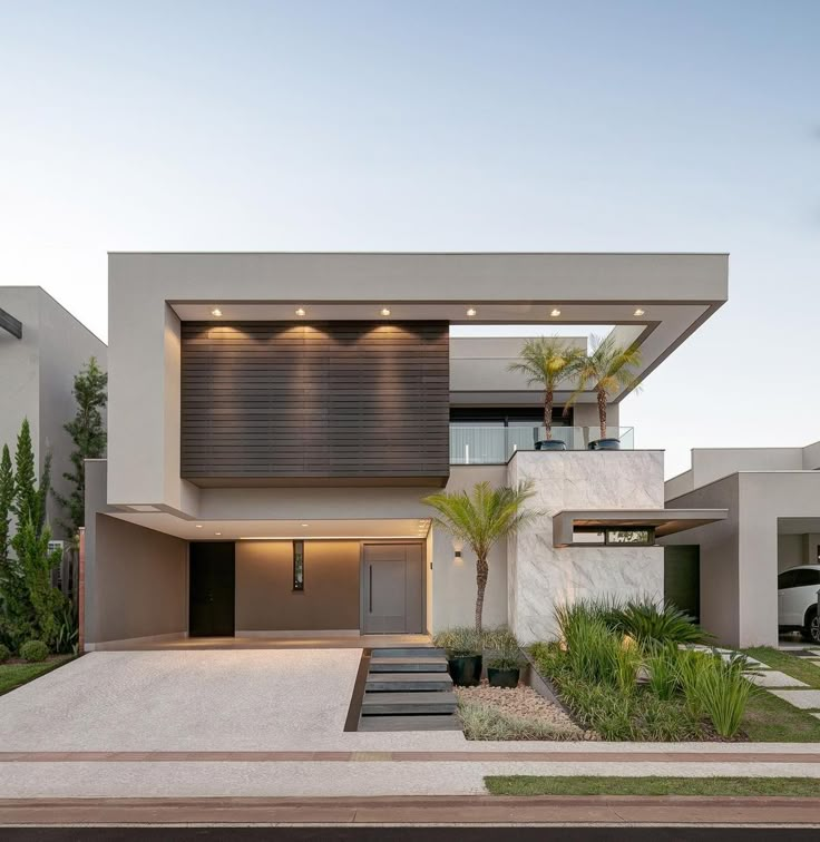 a modern house with an entrance and landscaping