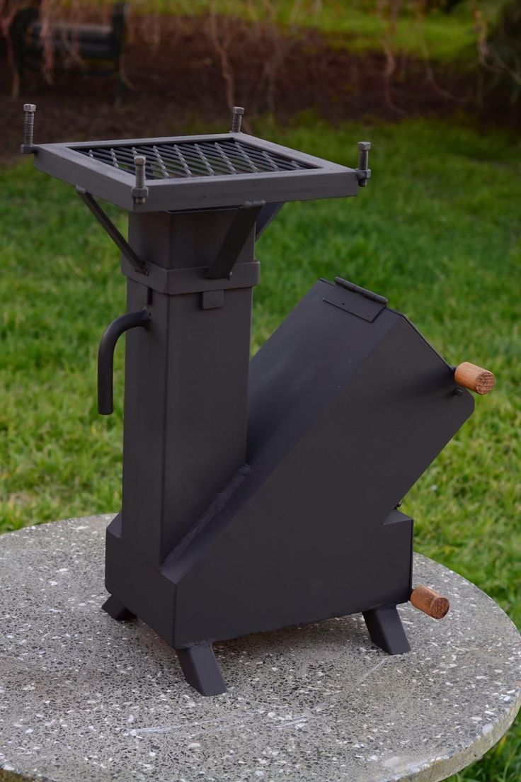 an outdoor grill sitting on top of a stone slab