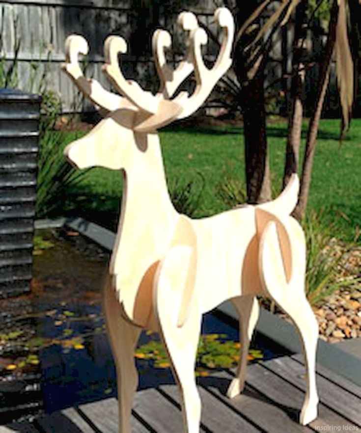 a wooden sculpture of a deer on a deck