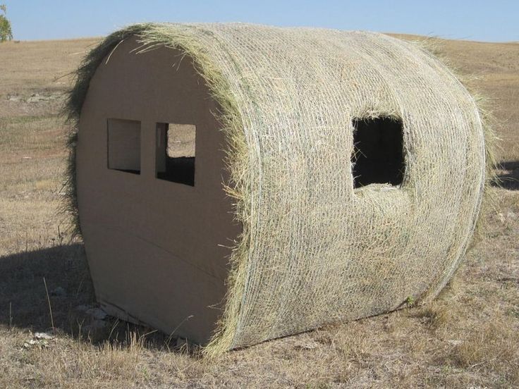 a large hay bale sitting on top of a dry grass field