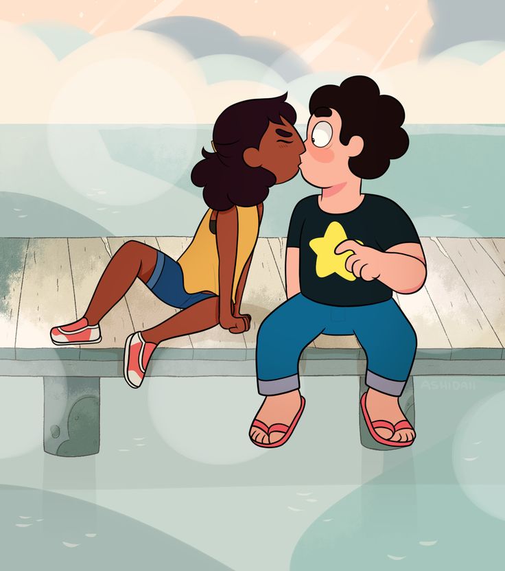 two people sitting on a bench kissing each other and one person is holding a star