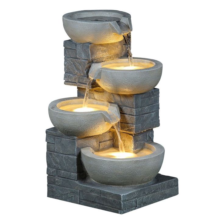 a water fountain with three bowls and lights