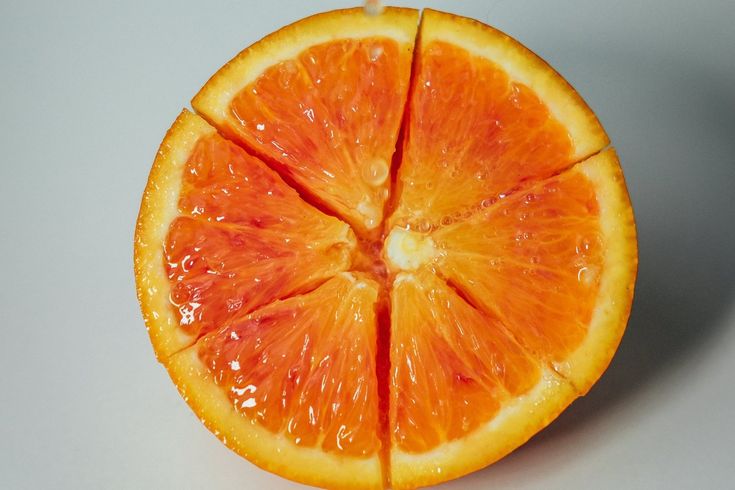 an orange cut in half sitting on top of a table