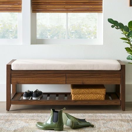 a pair of green shoes sitting on top of a wooden bench next to a window