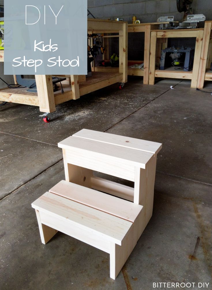 a step stool made out of wood sitting on top of a garage floor with the words diy kids step stool above it