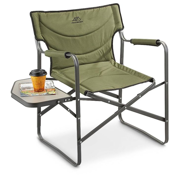 a folding chair with a tray and cup on the side, sitting next to it