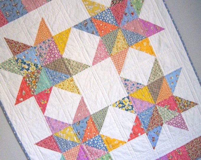 a multicolored quilt hanging on the wall