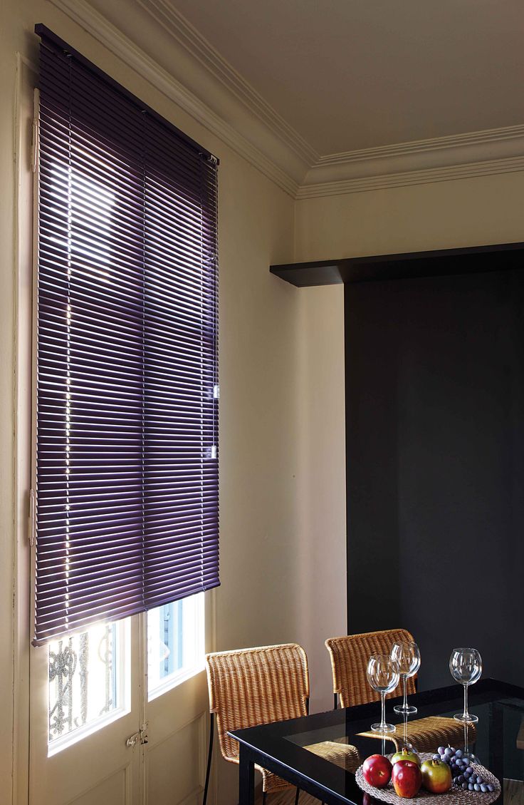 a dining room table with wine glasses and fruit on it