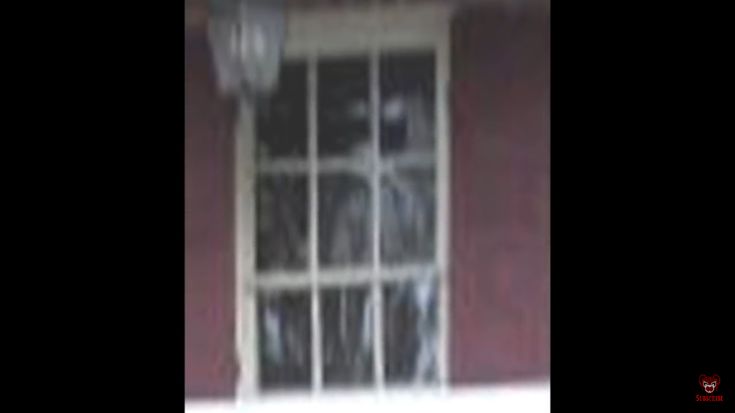 an image of a person behind bars on a door that is open to the outside