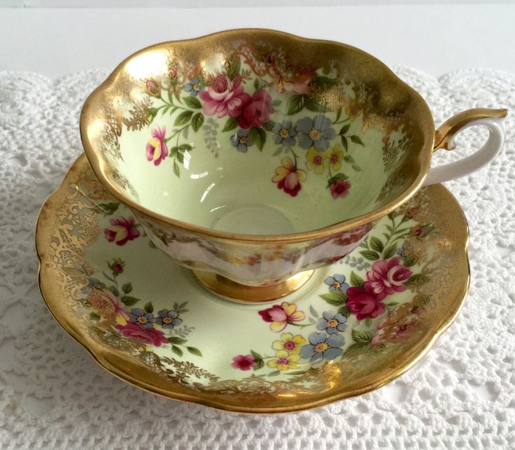 two cups and saucers on a doily